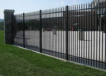 Black steel picket fencing are used to safeguard a factory.