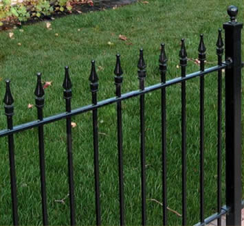 Black rod top fence panels with finials are used to protect lawns..