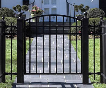 A black arched swing steel fence gates to protect the house from any attempt of trespass.